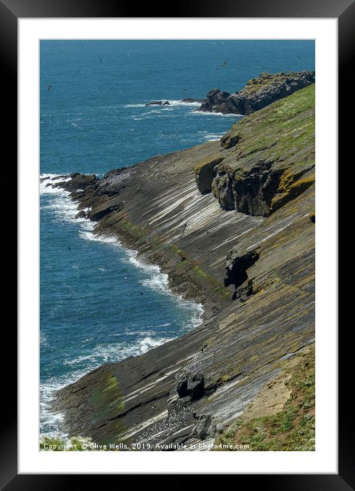 Rock meets the sea on Skomer Island Framed Mounted Print by Clive Wells