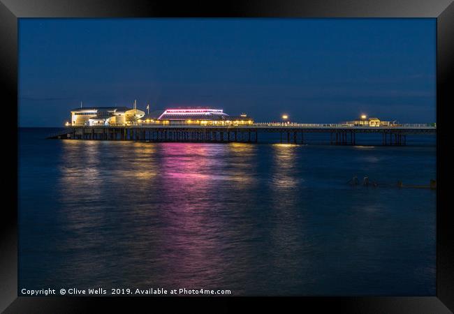 Cromer Pier at night in North Norfolk Framed Print by Clive Wells