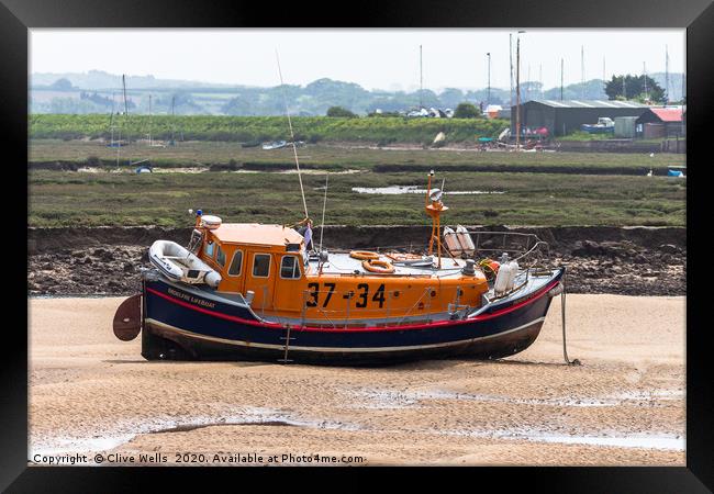 Lifeboat sitting on the mud flaps at Wells-Next-Se Framed Print by Clive Wells