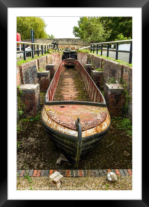 Abandoned shell of narrowboat at Stoke Brurne in N Framed Mounted Print by Clive Wells