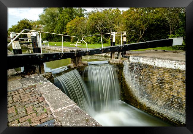 Overflowing lock gates at Stoke Brurne. Framed Print by Clive Wells