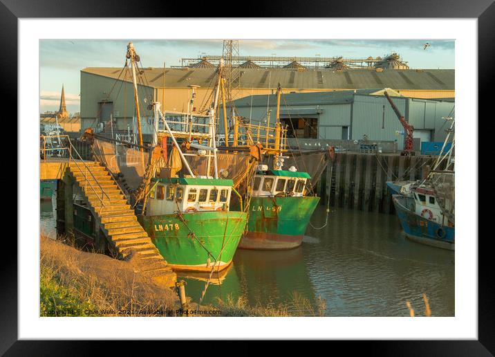 Fishing boats at low tide Framed Mounted Print by Clive Wells