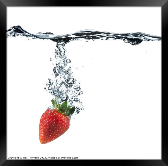 Vibrant Red Strawberry Dropped in Clear Water Framed Print by Phill Thornton