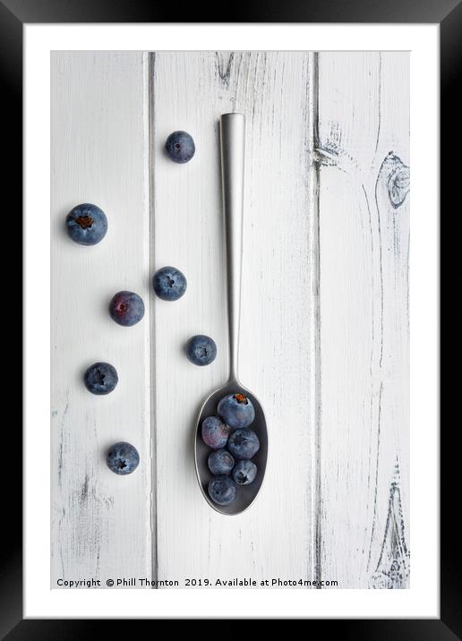 blueberries and a silver spoon on distressed white Framed Mounted Print by Phill Thornton