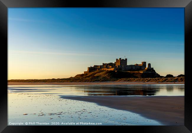 Sunrise over Bamburgh Castle Framed Print by Phill Thornton