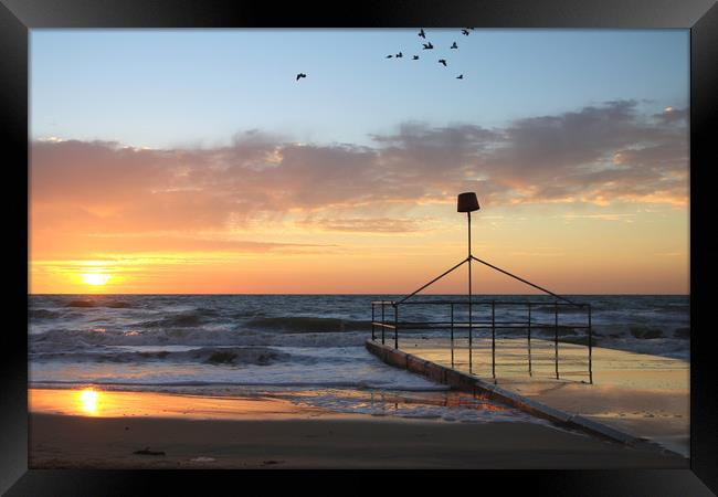 Dawn sunrise over seaside holiday resort Framed Print by Steve Mantell