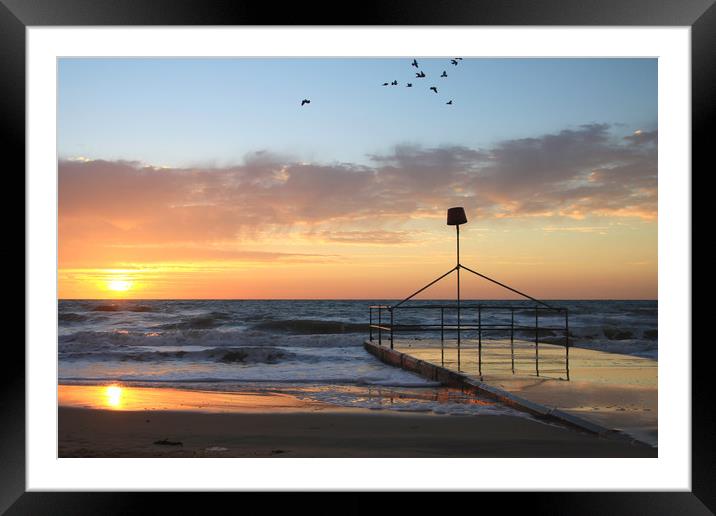 Dawn sunrise over seaside holiday resort Framed Mounted Print by Steve Mantell