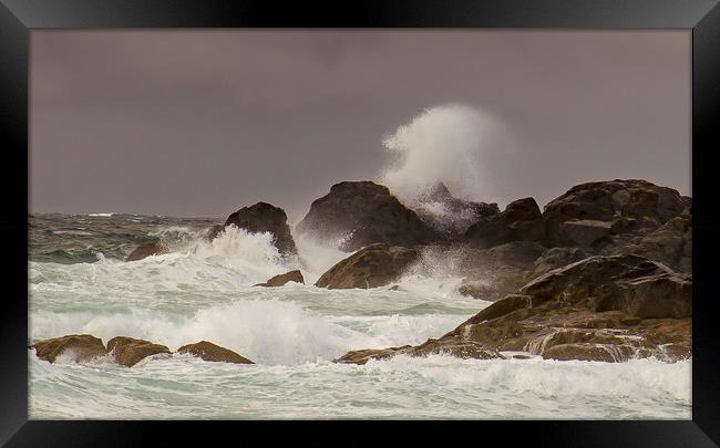 Stormy waves crashing against the rocks Framed Print by Steve Mantell