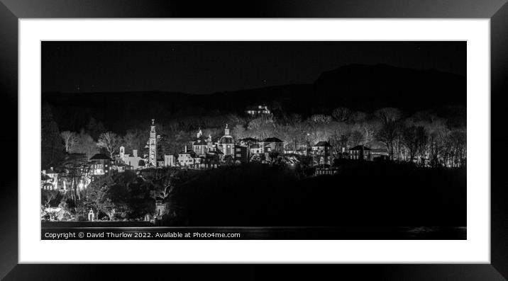 The lights of the Italianate village of Portmeirion illuminate the surrounding trees Framed Mounted Print by David Thurlow
