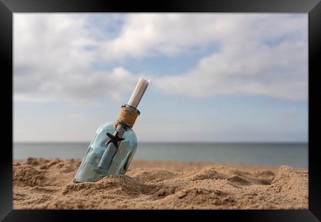 Message in a bottle on the sand Framed Print by Anthony Hart