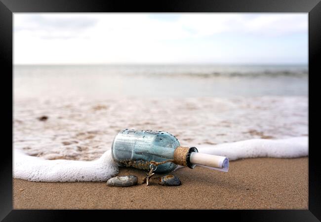 Message in a bottle in the surf Framed Print by Anthony Hart