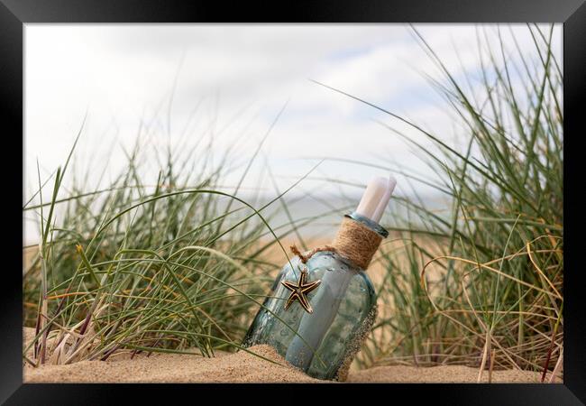 Message in a bottle in the dunes Framed Print by Anthony Hart