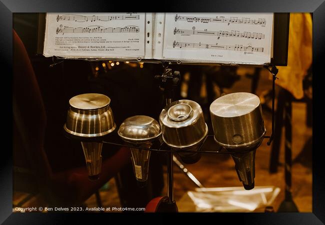 Trumpet mutes in a row with sheet music on a stand Framed Print by Ben Delves