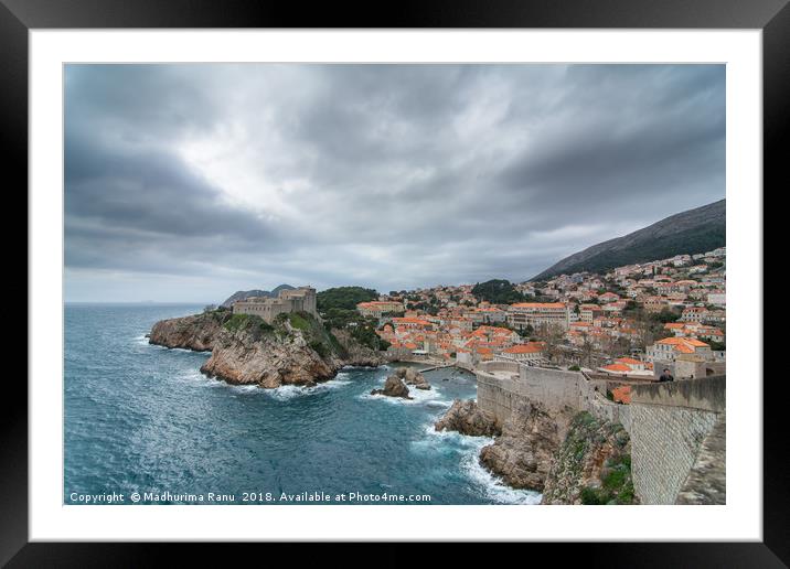 Waves crashing against the ancient city walls Framed Mounted Print by Madhurima Ranu