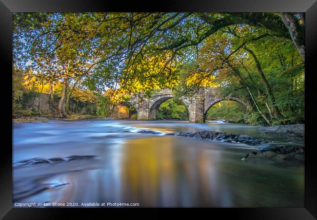 Serene Bridge Over River Dart Framed Print by Ian Stone