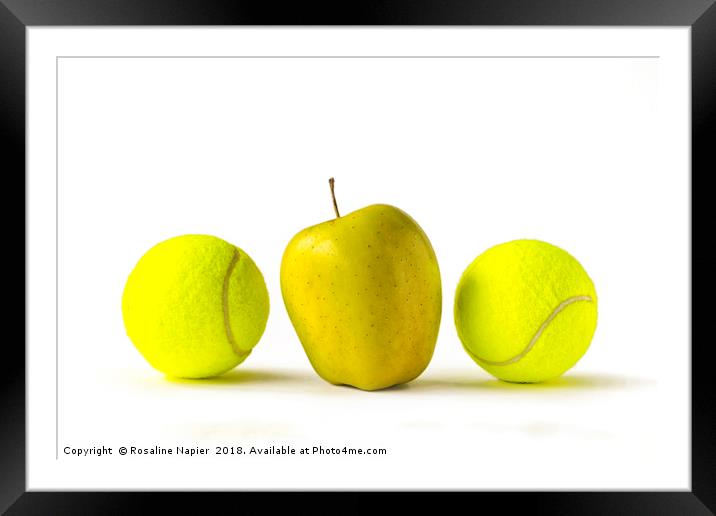 Yellow apple between two tennis balls Framed Mounted Print by Rosaline Napier