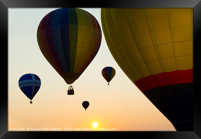 Balloons flying at the sunset Framed Print by Sergio Delle Vedove