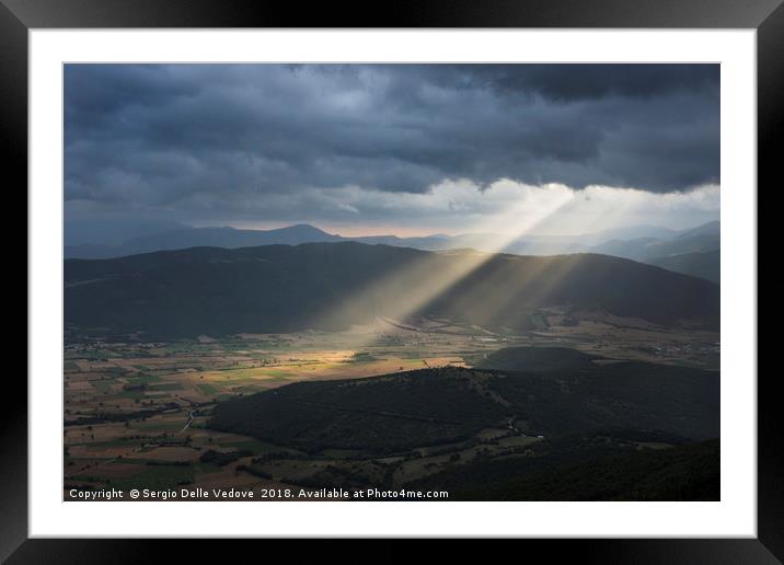 The sunrays through the clouds Framed Mounted Print by Sergio Delle Vedove