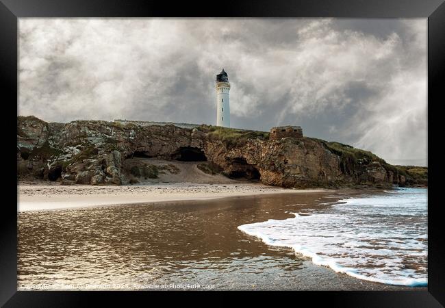 Lossiemouth lighthouse and Covesea caves Framed Print by Tom McPherson