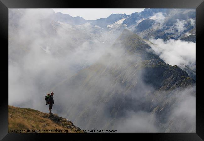 Hiker in France alps standing on edge of mountain  Framed Print by Dalius Baranauskas