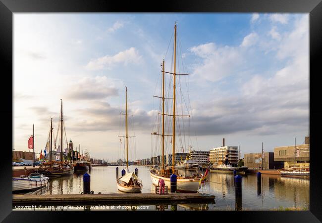 Scenic view of the port of Bremerhaven at sunset Framed Print by Juan Jimenez