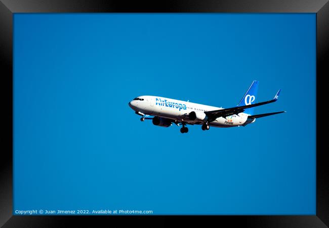 Boeing 737-800 passenger aircraft of the airline Air Europa flying before landing against sky Framed Print by Juan Jimenez