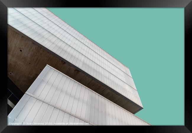 Low angle view of modern architecture glass facade against sky Framed Print by Juan Jimenez