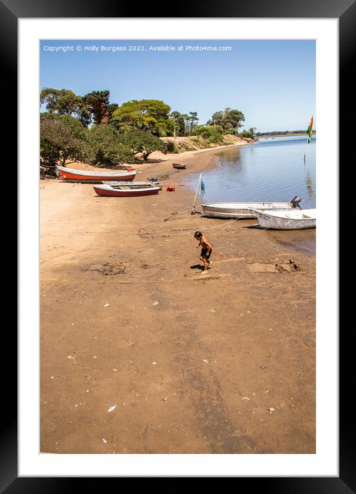 Punta De Este on the coast os South America, a boy playing on the beach  Framed Mounted Print by Holly Burgess
