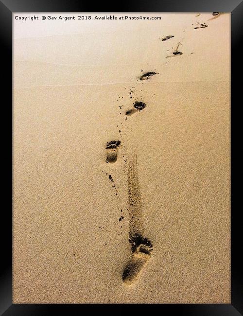 Footsteps in the sand Framed Print by Gav Argent