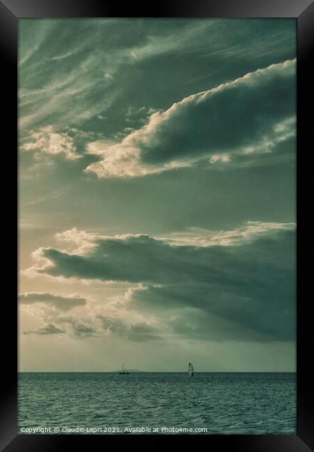 Sailing under cloudy sky Framed Print by Claudio Lepri