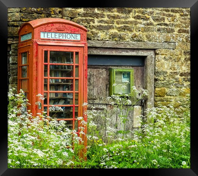 Old redundant red public telephone box or is it? Framed Print by Stephen Robinson