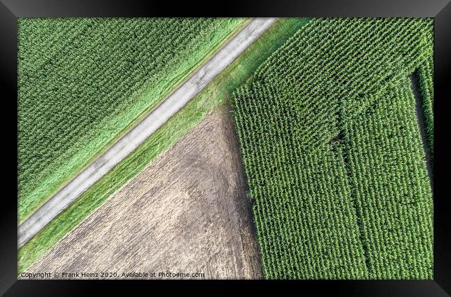 Aerial photograph of a harvested arable land next to a maize field Framed Print by Frank Heinz