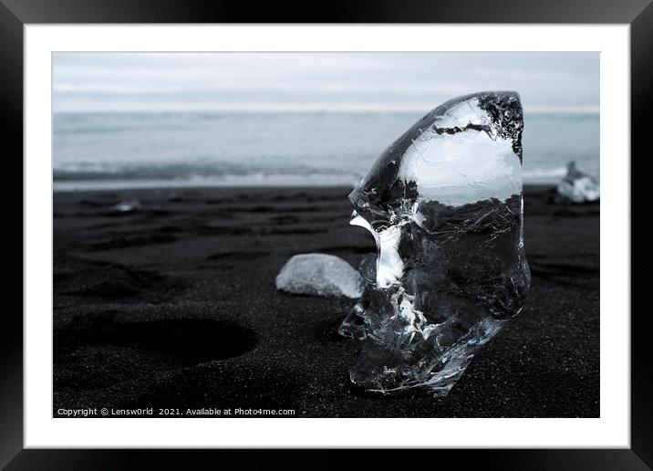 Clear piece of glacial ice on black sand Framed Mounted Print by Lensw0rld 