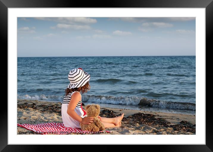 little girl with teddy bear sitting on beach Framed Mounted Print by goce risteski