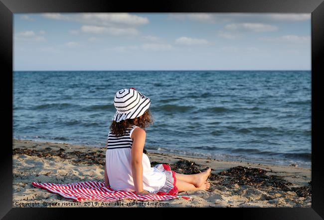 little girl sitting on beach Framed Print by goce risteski
