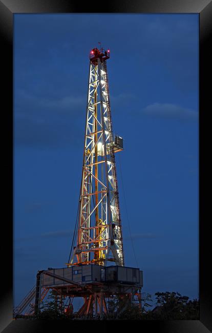 illuminated oil drilling rig on oilfield Framed Print by goce risteski