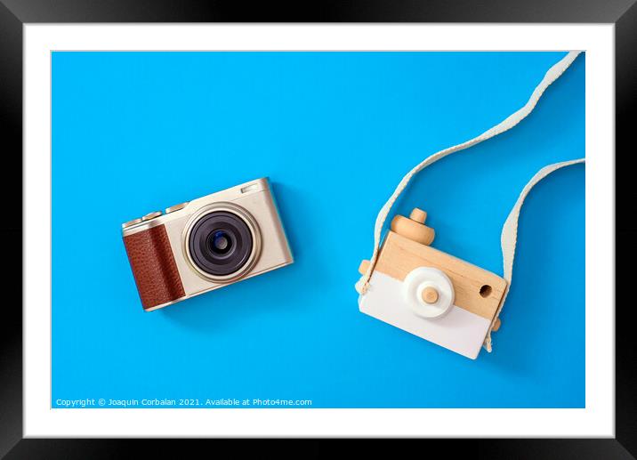 Two cameras, one modern and one old, compared one next to the ot Framed Mounted Print by Joaquin Corbalan