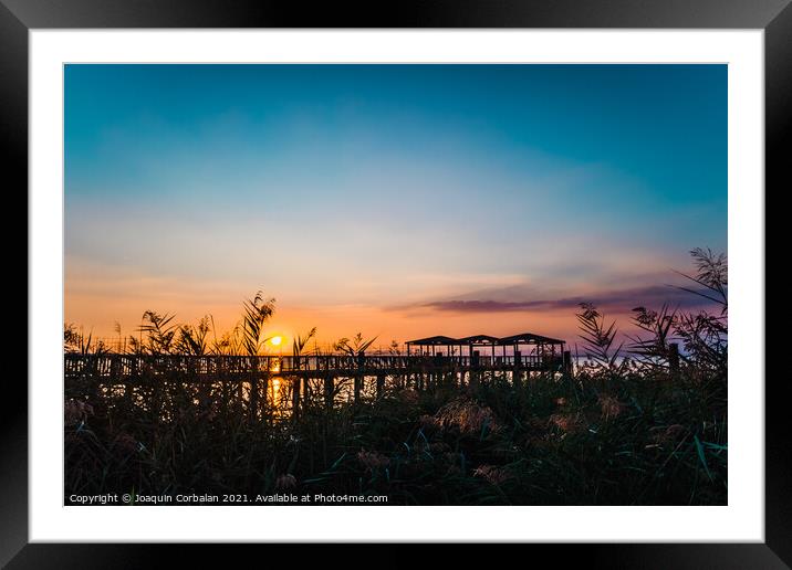 A beautiful sunset on Lago di Garda near the wooden jetty. Framed Mounted Print by Joaquin Corbalan