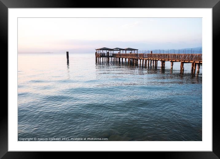 A beautiful sunset on Lago di Garda near the wooden jetty. Framed Mounted Print by Joaquin Corbalan
