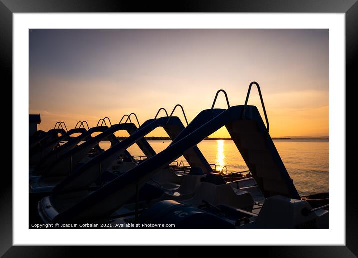Silhouette of water scooters parked on the shore at the end of t Framed Mounted Print by Joaquin Corbalan