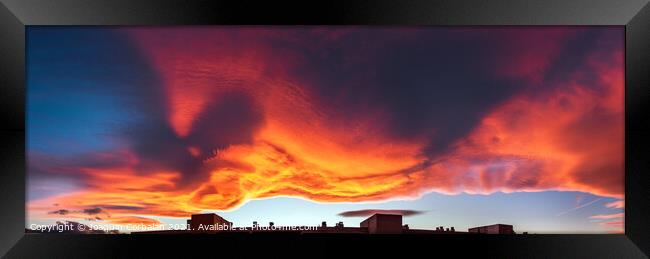 A large cloud with curious wavy shapes and warm reddish colors d Framed Print by Joaquin Corbalan