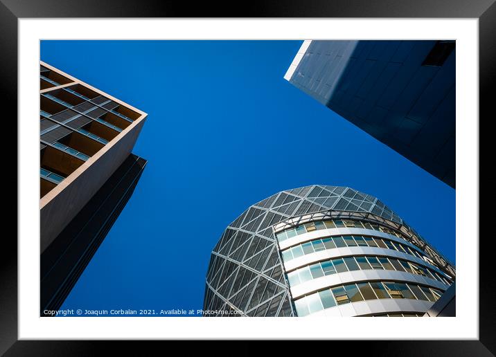 Tall office buildings, viewed from below, modern and rounded, wi Framed Mounted Print by Joaquin Corbalan