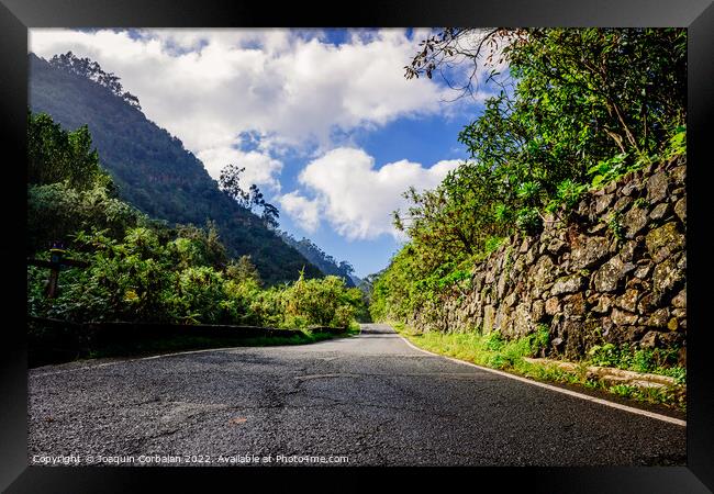Sunny day on a road between mountains of the Canary Islands, in  Framed Print by Joaquin Corbalan