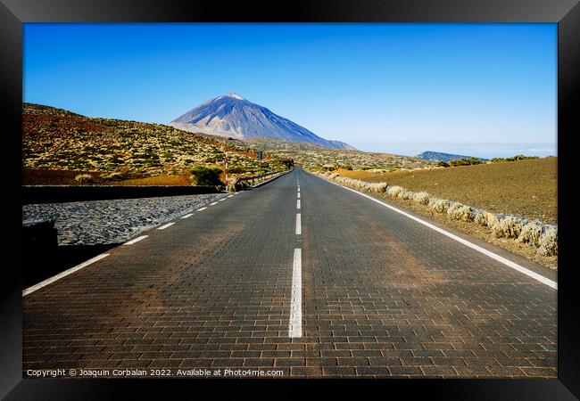 A paved road leads adventurous tourists to the highest peak in S Framed Print by Joaquin Corbalan