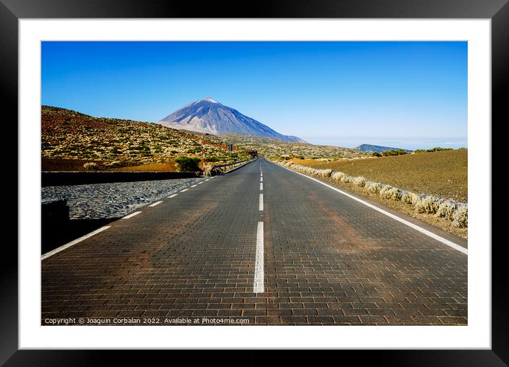 A paved road leads adventurous tourists to the highest peak in S Framed Mounted Print by Joaquin Corbalan