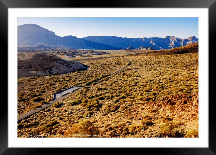 A mountain road crosses a spectacular valley at noon near Mount  Framed Mounted Print by Joaquin Corbalan