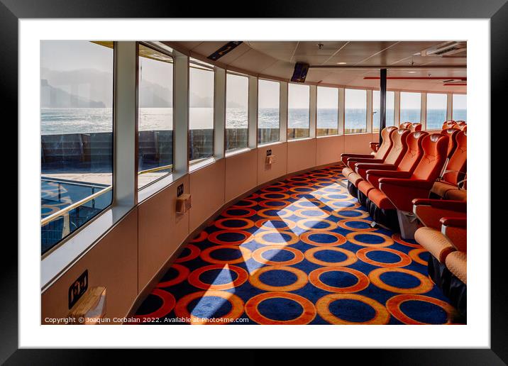 Empty seats inside a maritime ferry for passengers, before saili Framed Mounted Print by Joaquin Corbalan