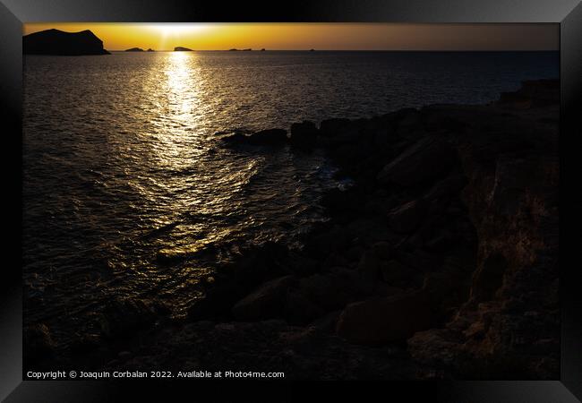 A warm sunset with the sun reflecting on the surface of the sea, Framed Print by Joaquin Corbalan