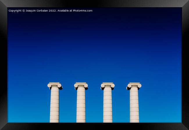 Four classical ionic columns, isolated on blue sky background Framed Print by Joaquin Corbalan