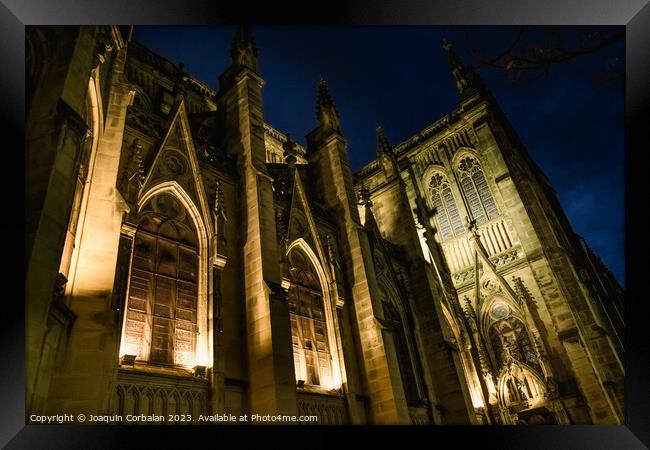 The cathedral of San Sebastian is illuminated at night in a ghos Framed Print by Joaquin Corbalan